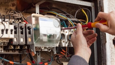Repair of old electrical switchgear. An electrician replaces old electrical wiring devices 