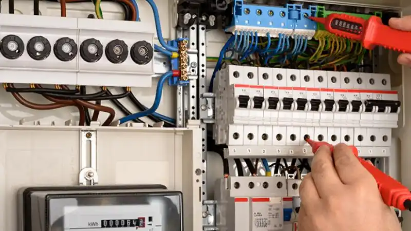 An electrician testing a fuse box.