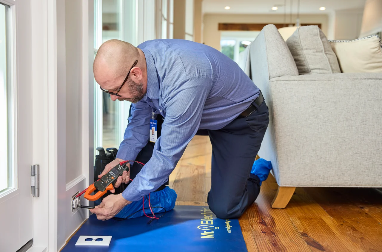 Local residential electrician testing home wiring and wall outlets