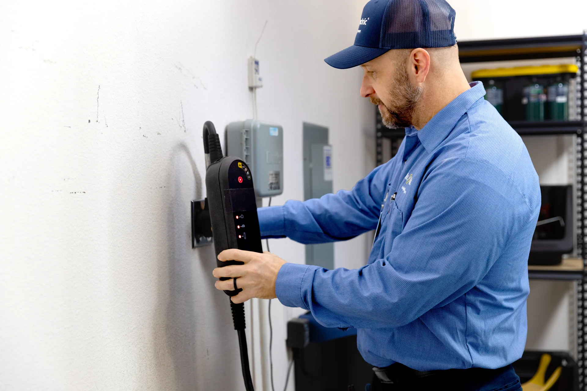 Professional electrician installing an electric vehicle EV charger in a garage