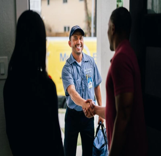 Mr. Electric electrician greeting a family at their door. 