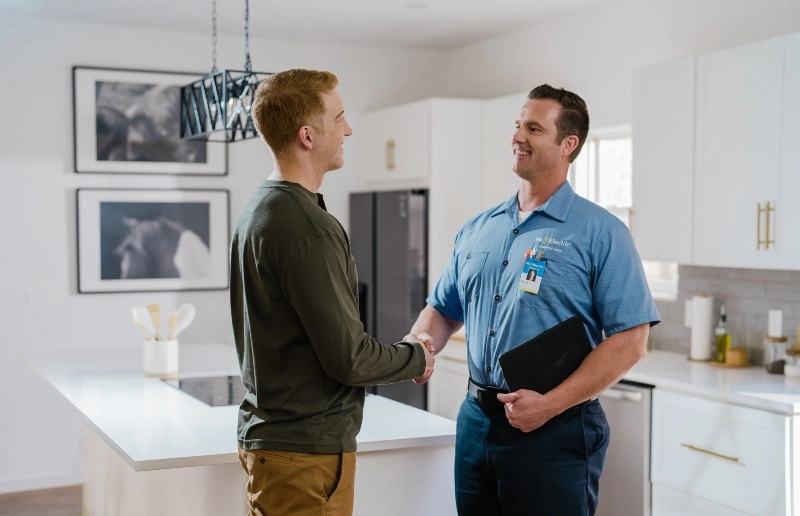 A Mr. Electric of Virginia Beach North electrician and customer during a residential service appointment.