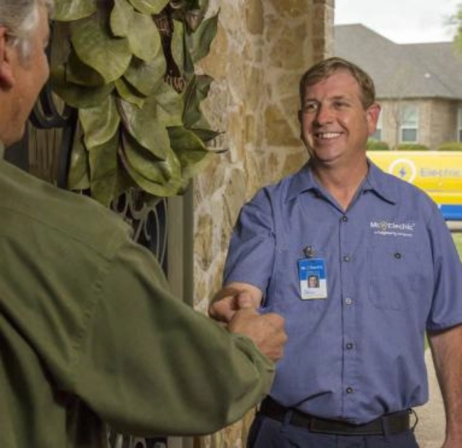 mre technician shaking hands with customer.