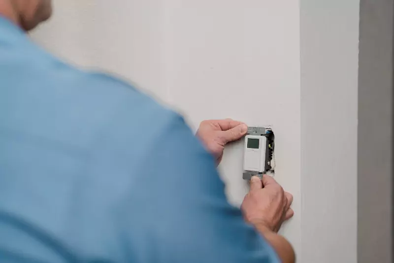 A Mr. Electric of Gastonia electrician installing a light timer switch 