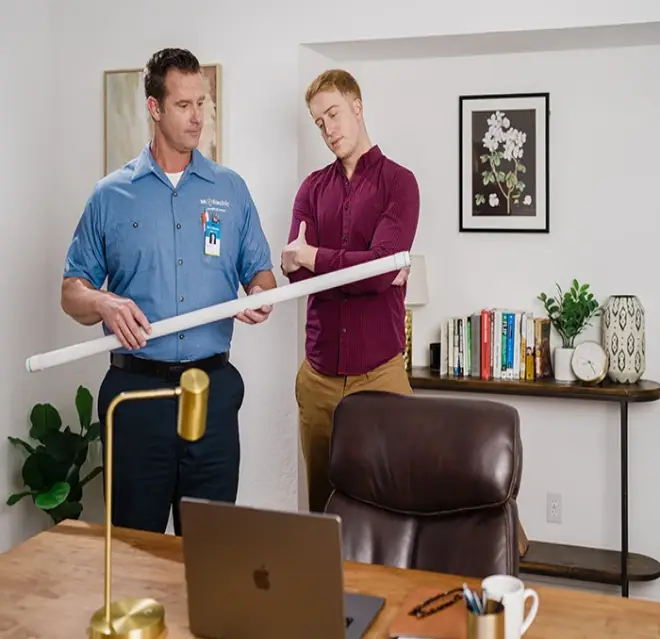 Mr. Electric electrician & customer in an office discussing commercial specialty lighting.