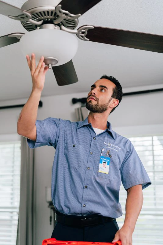 Mr. Electric electrician performing a ceiling fan installation