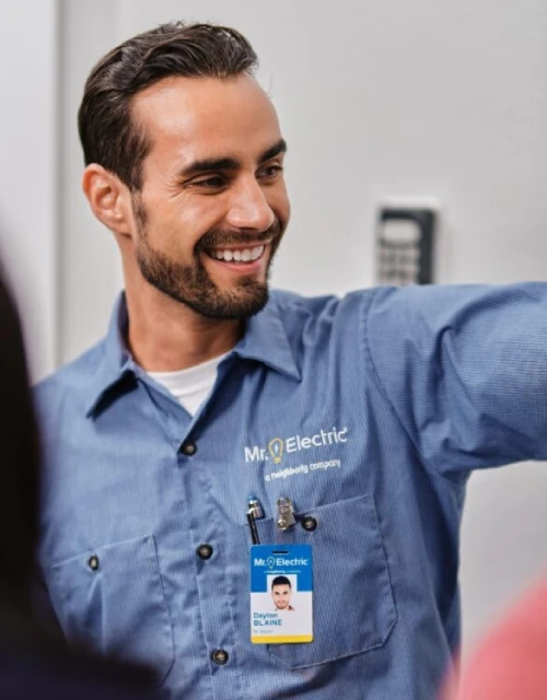 Close-up of male Mr. Electric associate in branded blue collared shirt.