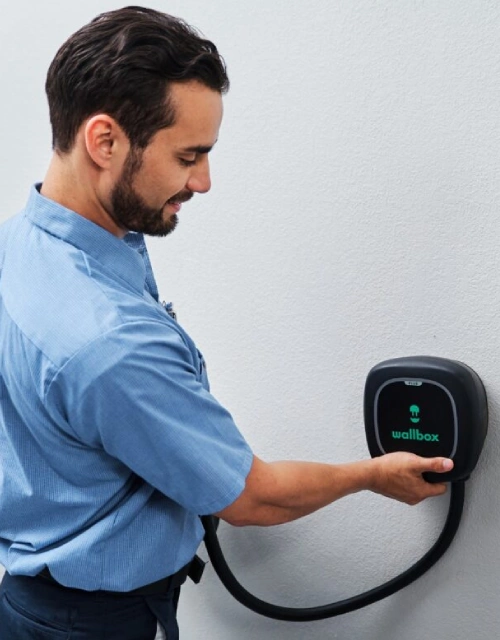 MRE electrician installing electric vehicle charger.