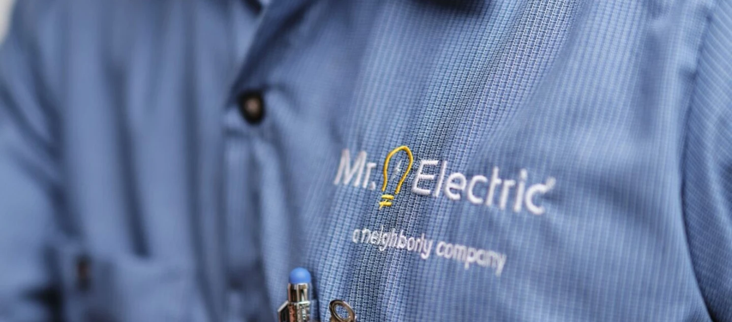Mr. Electric close up of logo on workshirt.