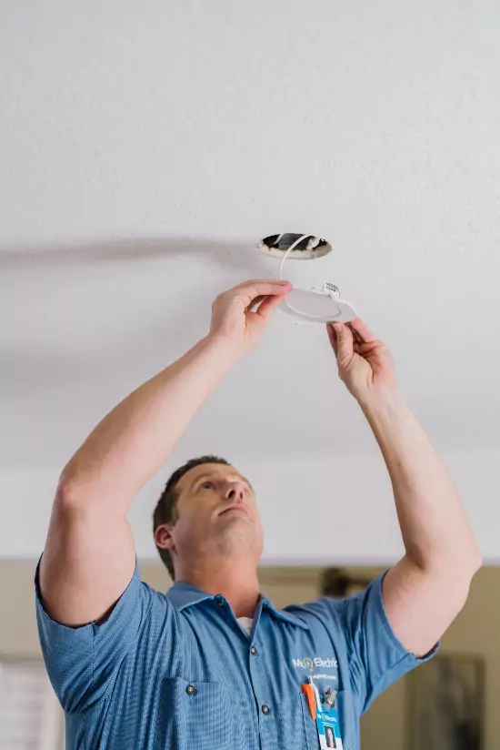 Mr. Electric of Allegan electrician repairing a flush mount ceiling light.