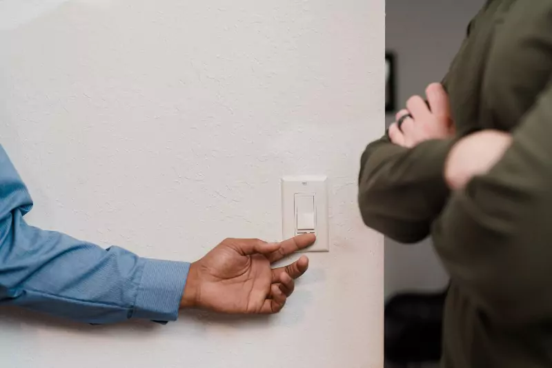 A Mr. Electric of Knoxville electrician testing out a light dimmer