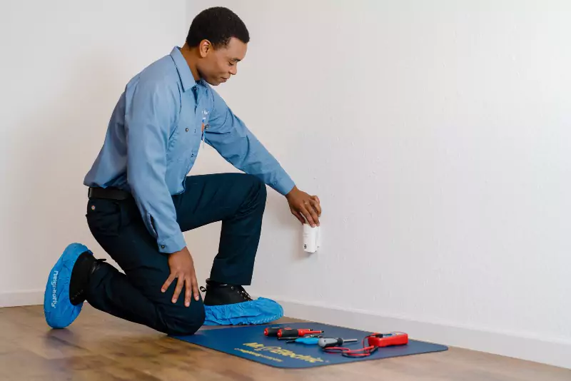 Mr. Electric electrician installing a power outlet