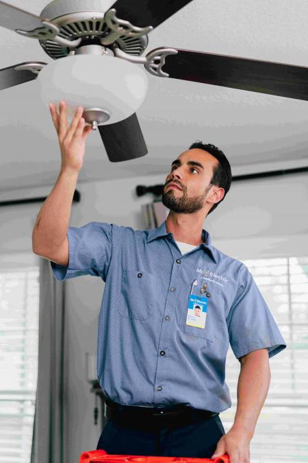 Mr. Electric of Central Iowa electrician installing an indoor light.