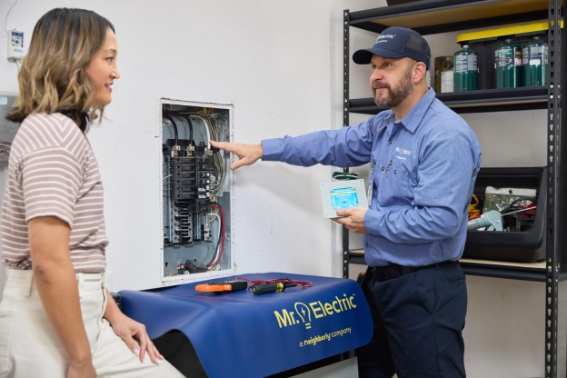 MRE Electrician demonstrating electrical wiring to a customer.