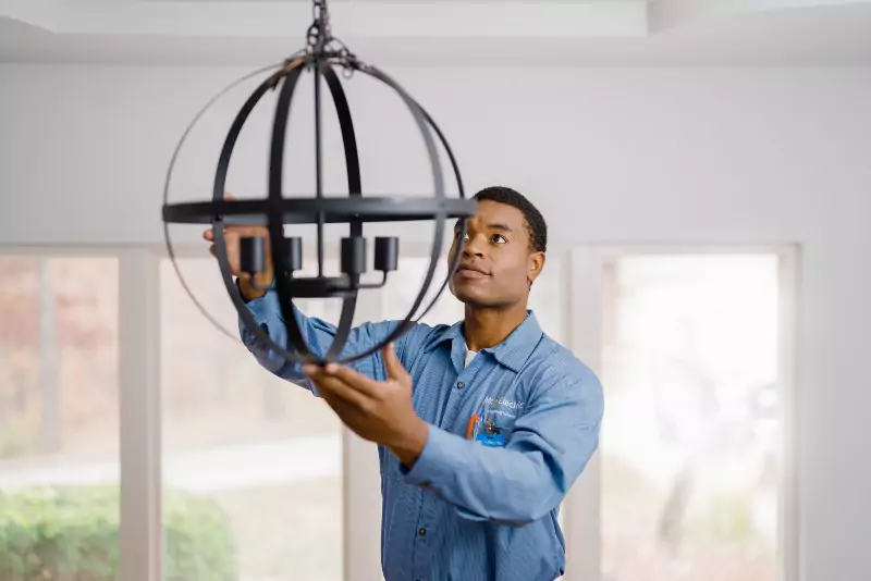 Mr. Electric of Allegan, Ottawa & Van Buren electrician installing a chandelier