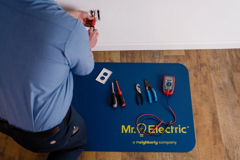 Mr. Electric of Allegan, Ottawa & Van Buren electrician repairing an electrical outlet in Plainwell, MI