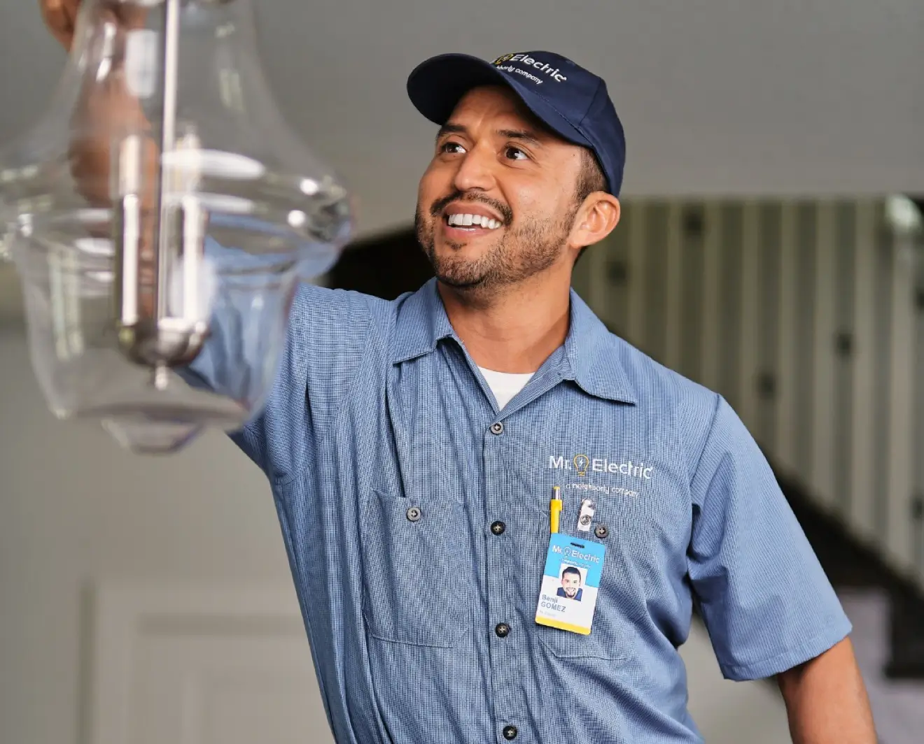 Mr. Electric technician installing a chandelier.