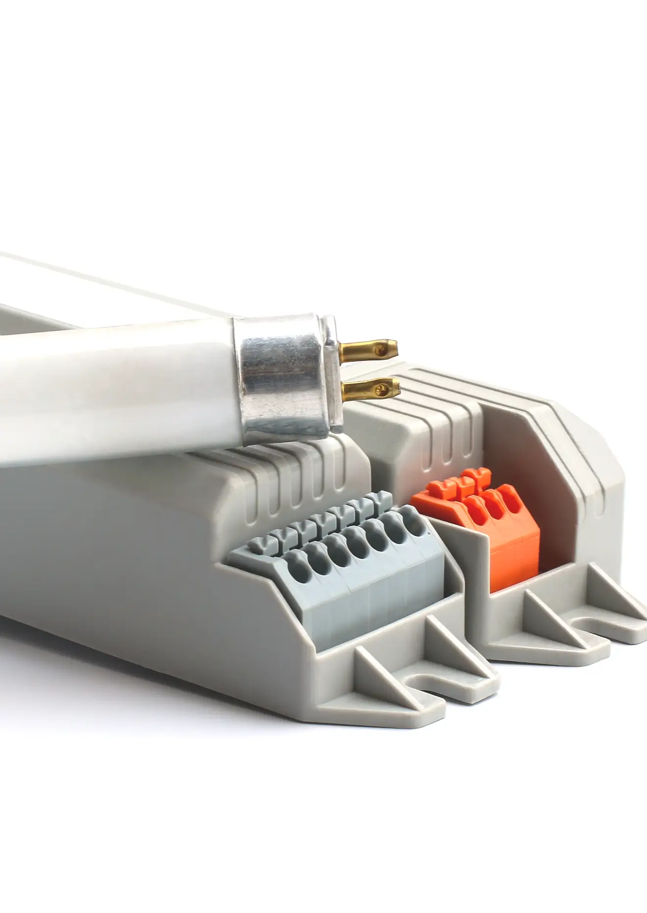 Close-up of a white fluorescent tube resting across a gray electrical ballast, focusing on the reflector socket and connection point in a product shot.