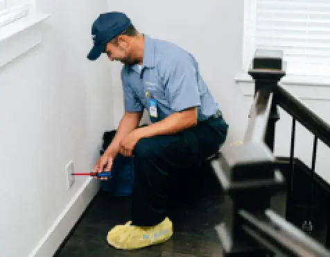 Mr. Electric technician repairing an outlet.