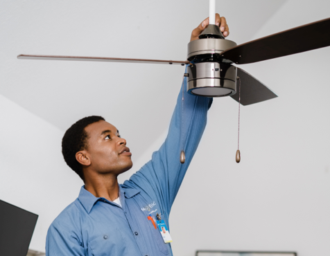 Mr. Electric technician installing a ceiling fan.