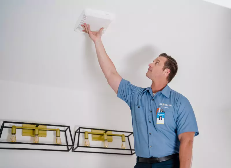 A Mr. Electric of the Coastal Empire electrician installing a carbon monoxide detector