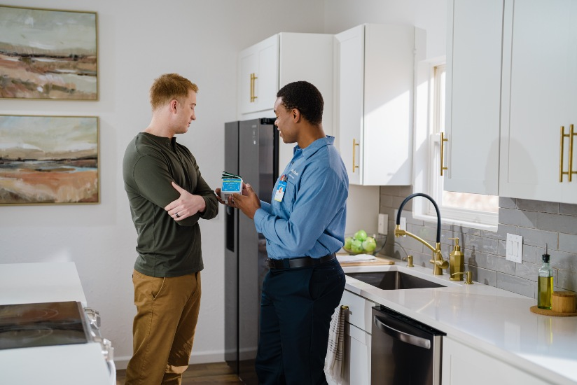 Mr. Electric electrician explaining electrical code updates to a couple