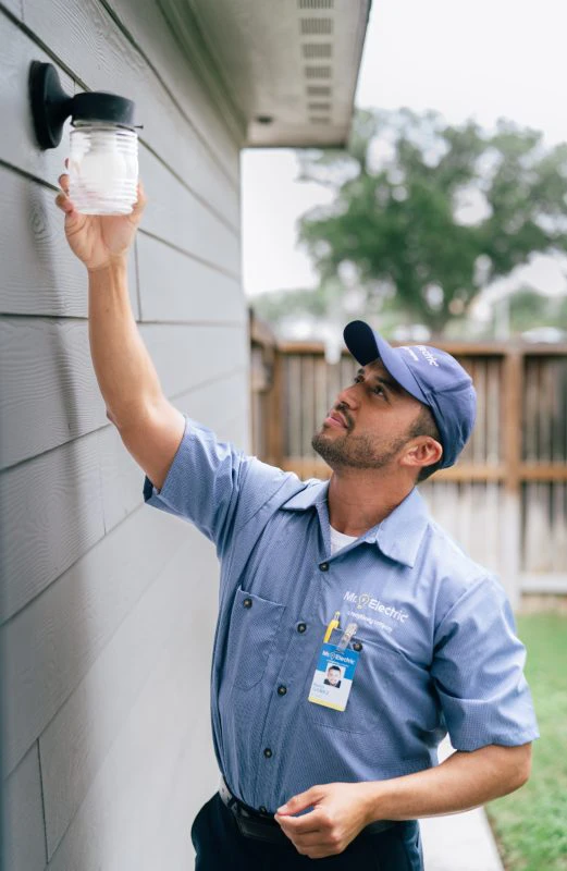 Mr. Electric electrician completing a light bulb replacement