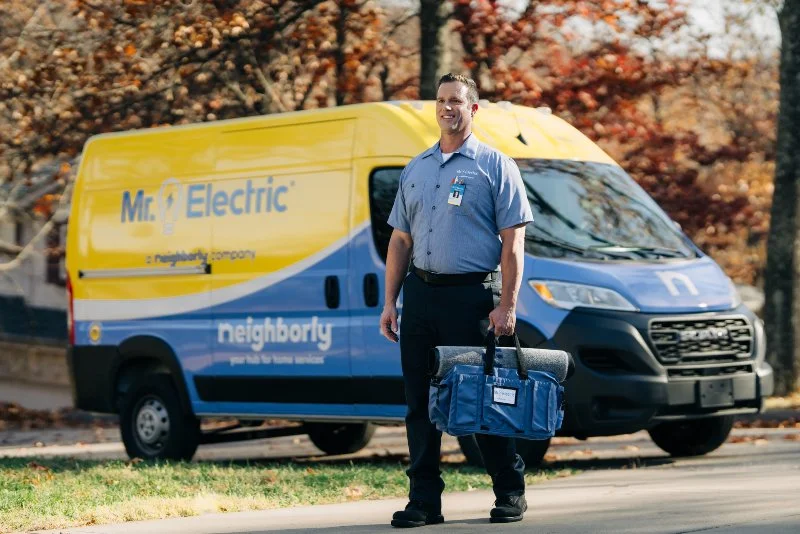 A Mr. Electric electrician arriving to install patio lighting