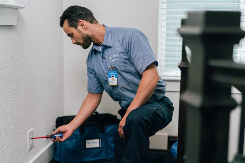 Mr. Electric electrician explaining circuit breaker replacement to a customer