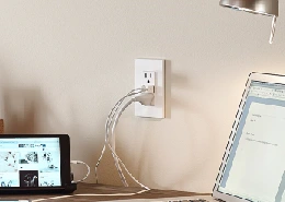 Laptop and iPad plugged into a USB outlet.