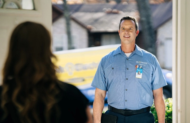 Mr. Electric electrician greets customer before doing home wiring upgrades