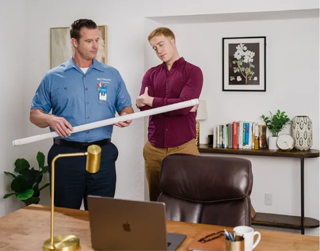 Mr. Electric electrician & customer in an office discussing commercial specialty lighting 