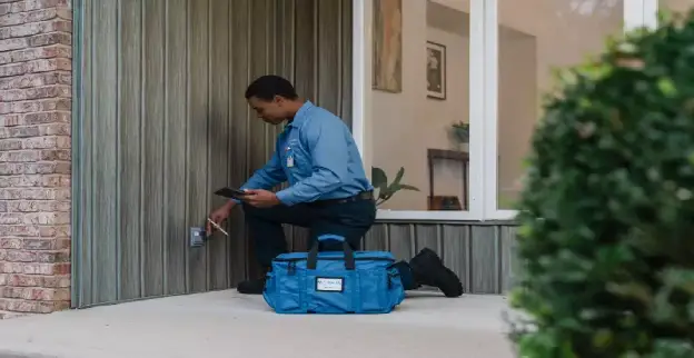Mr. Electric electrician inspecting an outdoor outlet