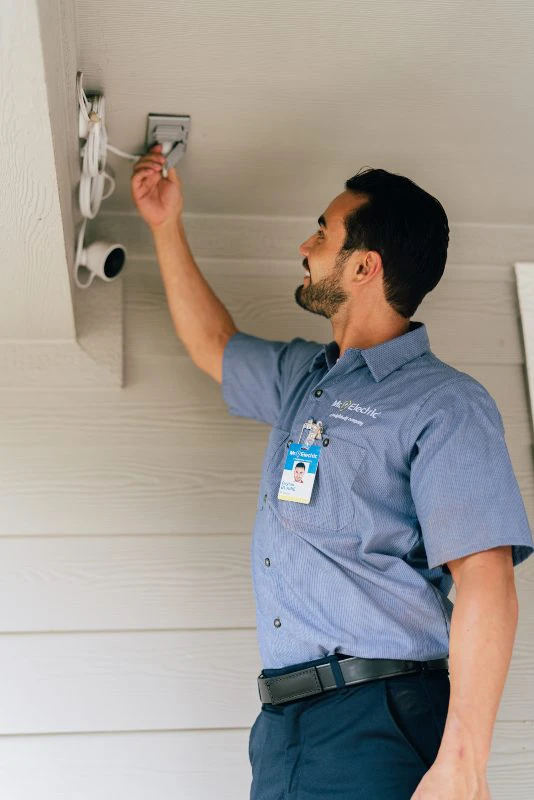 Mr. Electric electrician installing motion sensor security lights