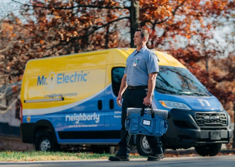 Mr. Electric electrician walking to customer's home to install landscape lighting 