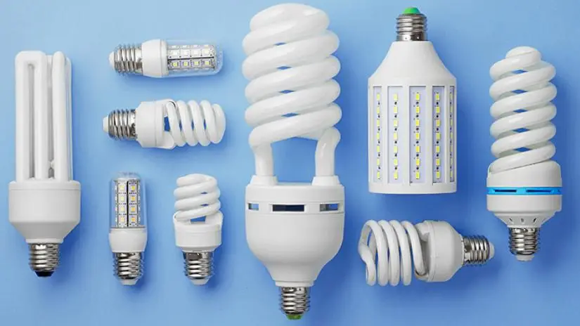 Several types of LED lightbulbs laid out on a blue background.