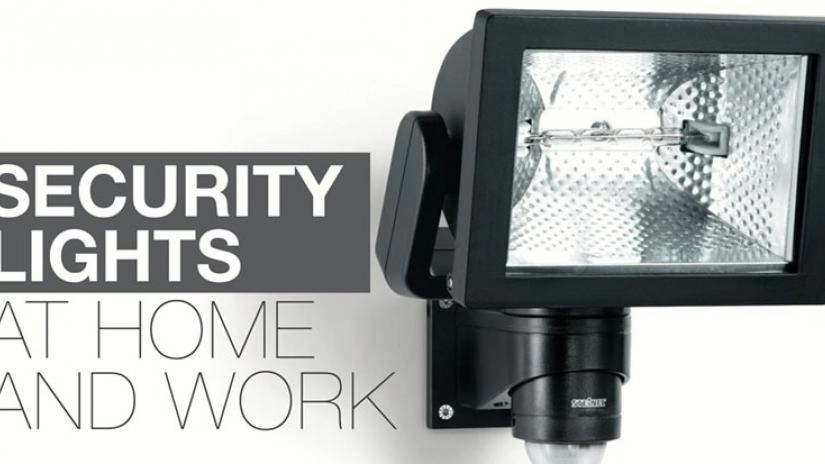 A picture of an outside black security light.