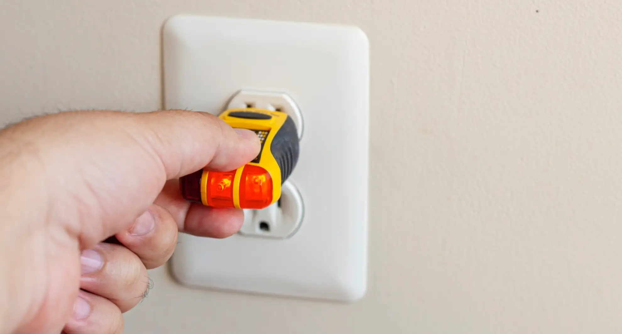 Testing power outlet with outlet tester tool