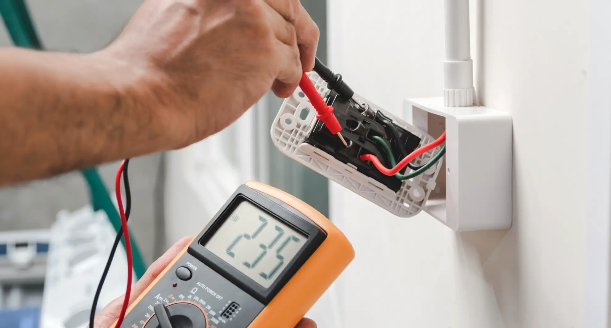 Measuring voltage at electrical wall outlet with multimeter
