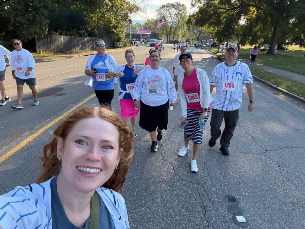 A group of people running on a road.