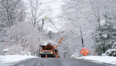 Worker trying to repair outside electrical lines after a winter storm.