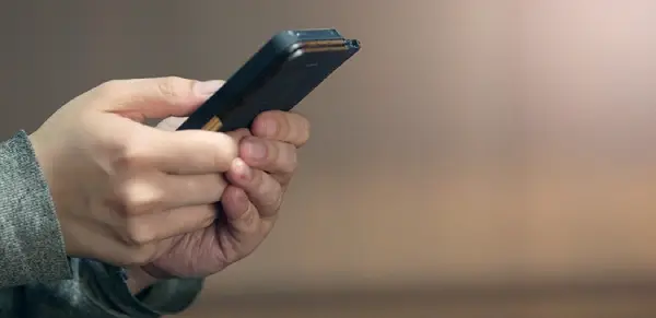 Hands with smartphone.