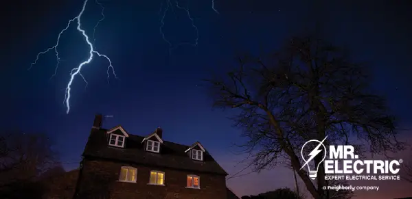 Lightning in sky above house.