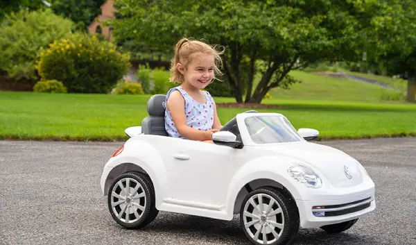 Girl in electric toy car.